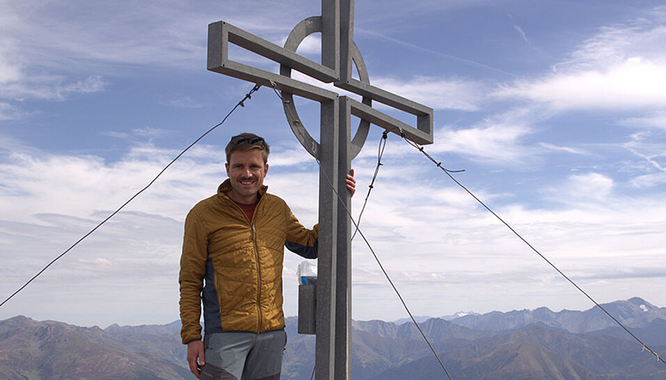 Sebastian Kamann on top of a mountain
